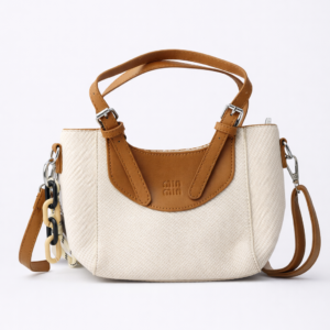 White handbag with brown leather accents on a white background