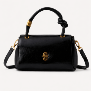 Black handbag with gold accents on a white background