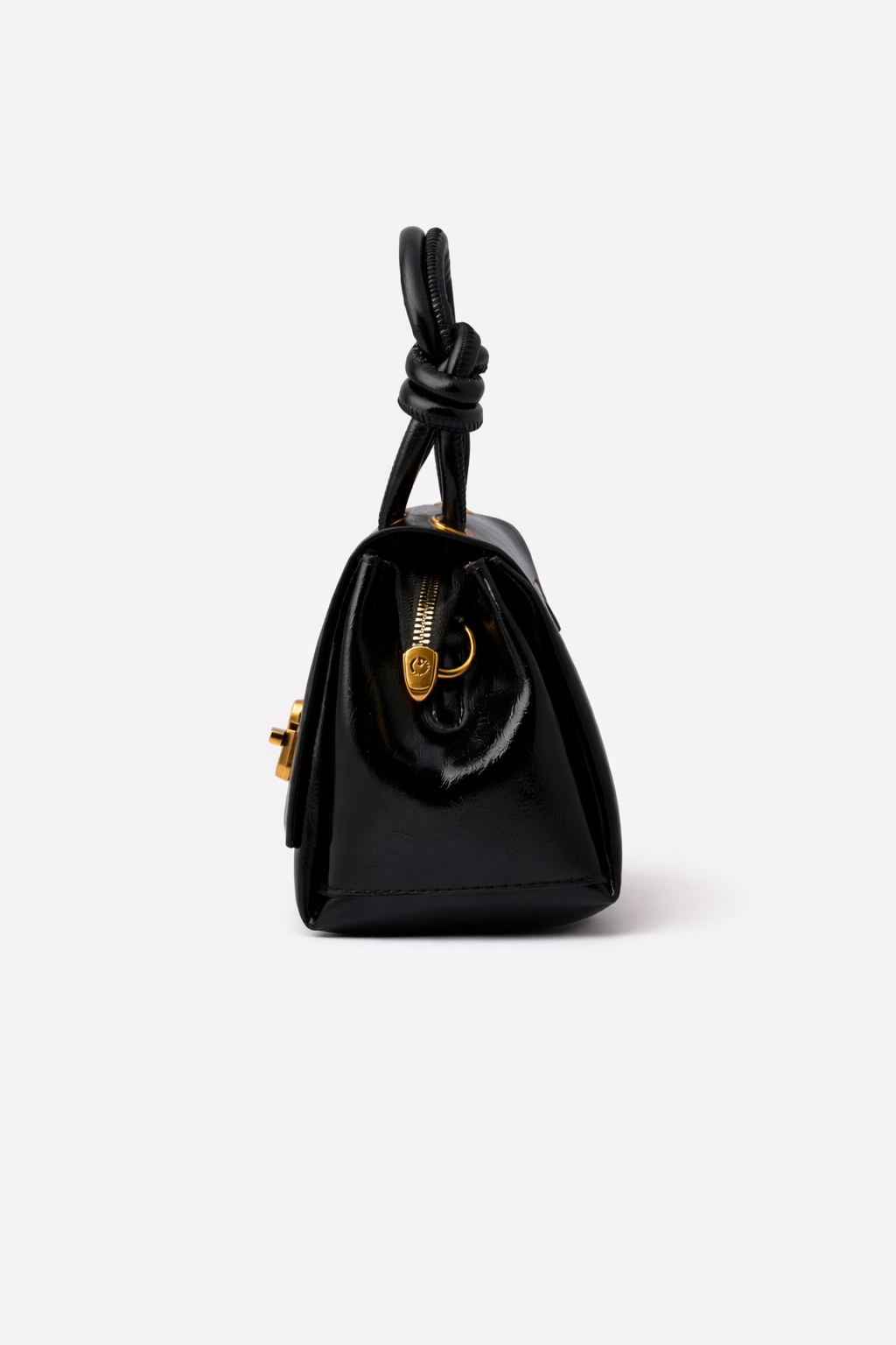 Black handbag with a knot detail on a white background