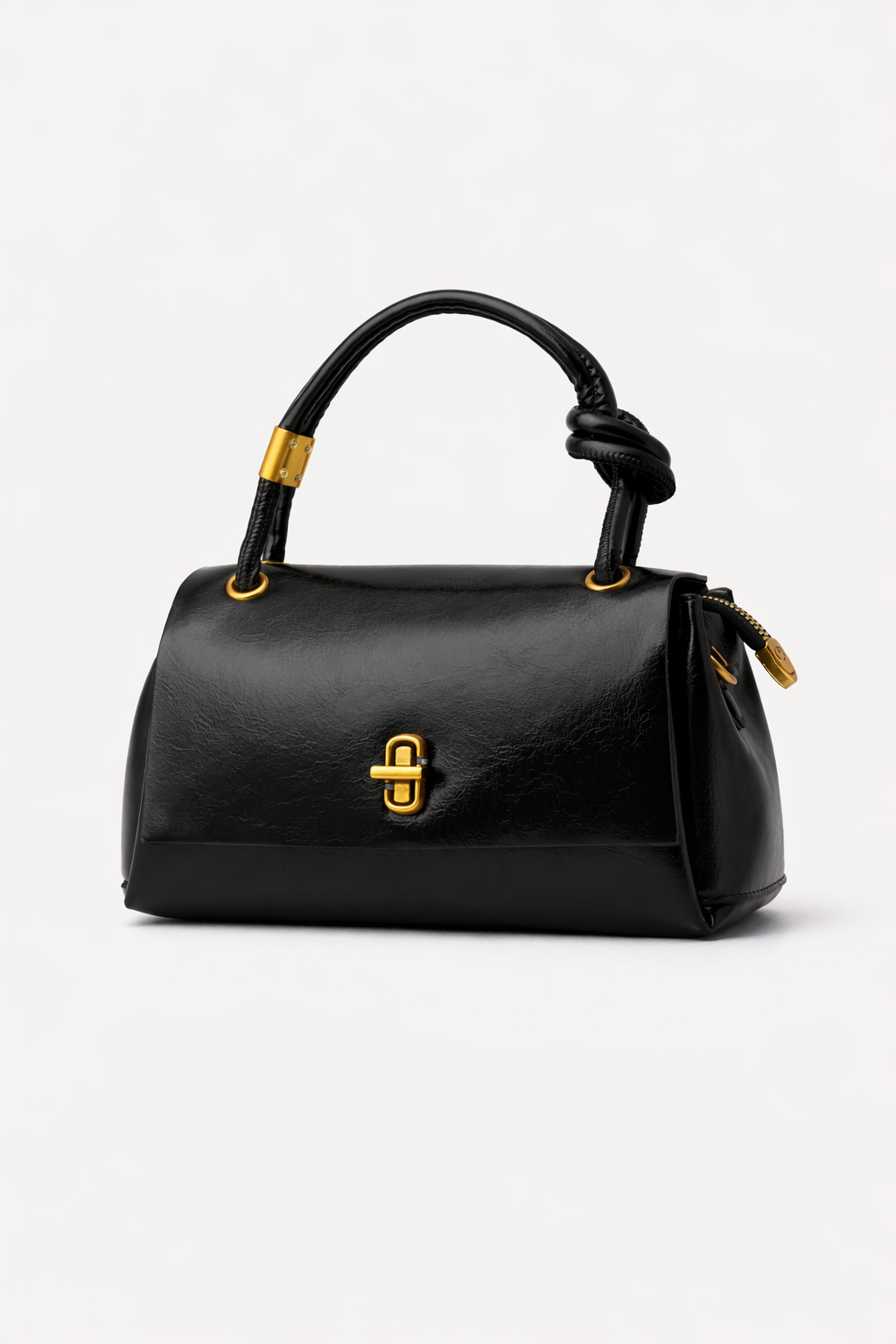 Black handbag with gold accents on a white background